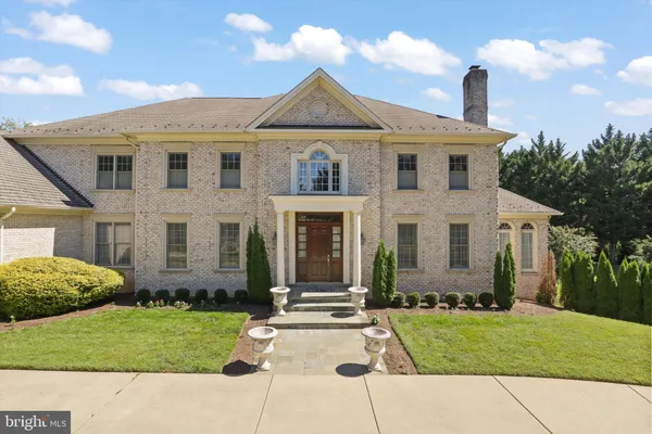 a front view of a house with a garden and patio