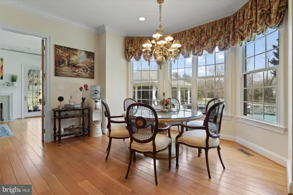 a view of a patio with table and chairs potted plants with floor to ceiling window