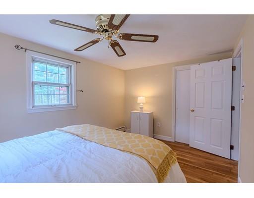 37 Governor Fuller Road Billerica, MA 01821 - Photo 16 of 27 a bedroom with a bed and a chandelier