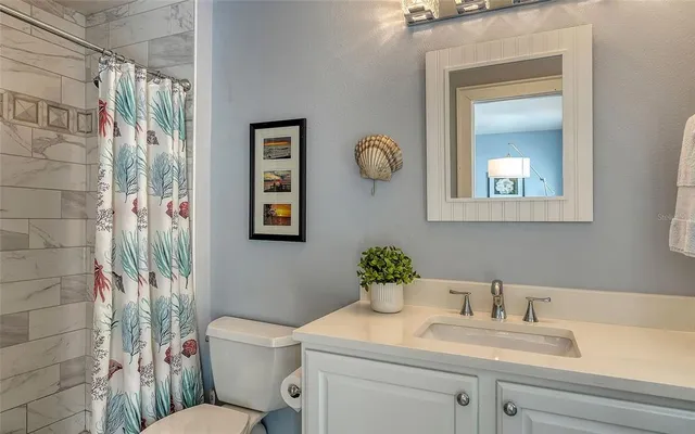 an aerial view of a house with a yard potted plants and large tree