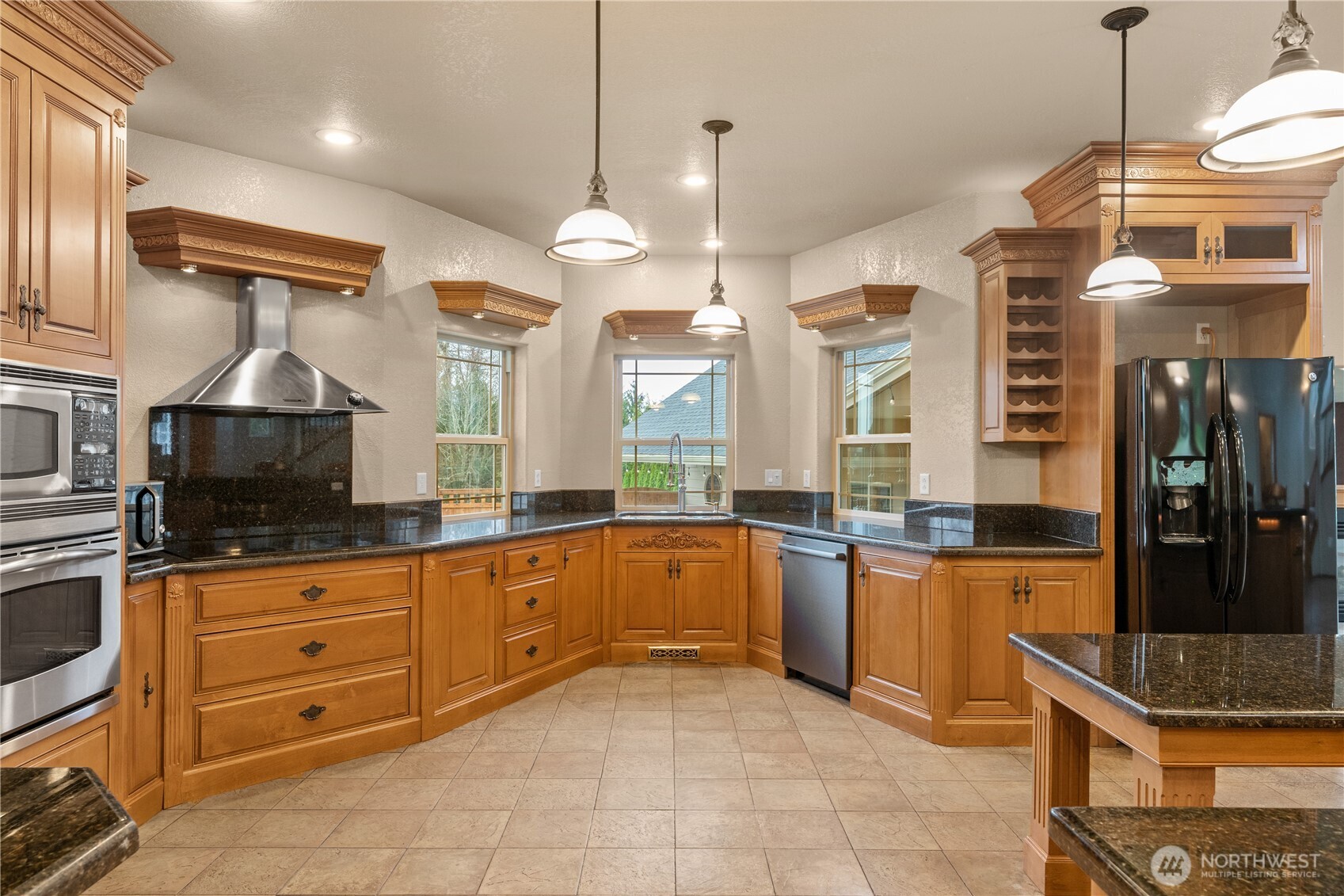 100 9th Street South Montesano, WA 98563 - Photo 6 of 40 a large kitchen with stainless steel appliances granite countertop a stove a sink and a refrigerator