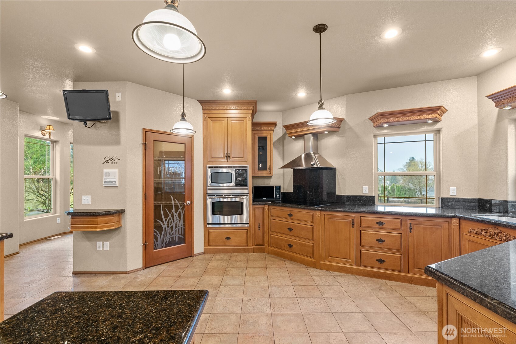 100 9th Street South Montesano, WA 98563 - Photo 9 of 40 a kitchen with stainless steel appliances kitchen island granite countertop a refrigerator and stove