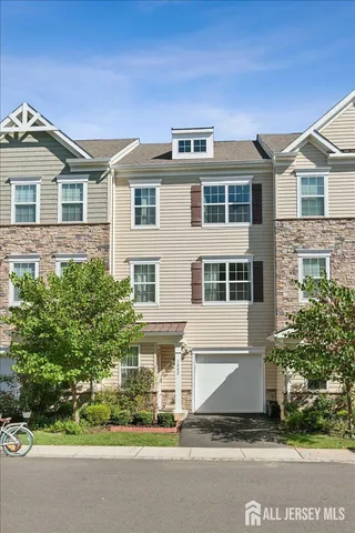a view of a house with a yard and potted plants