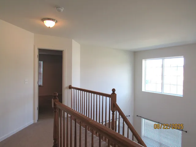 a view of a hallway with windows