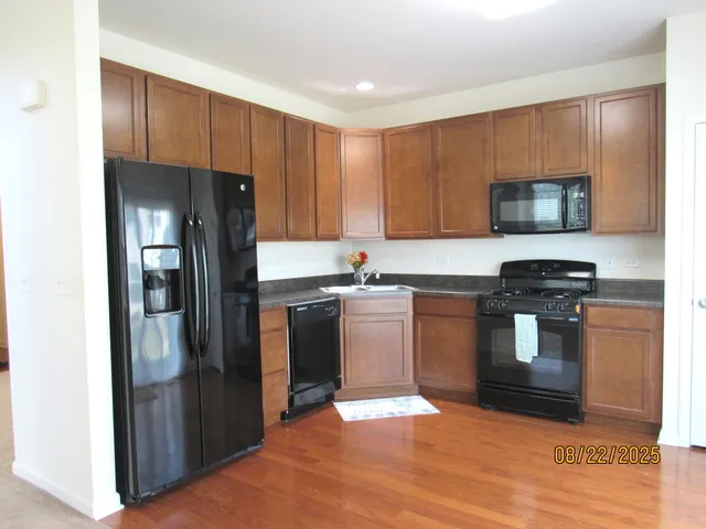 a kitchen with a refrigerator stove and sink