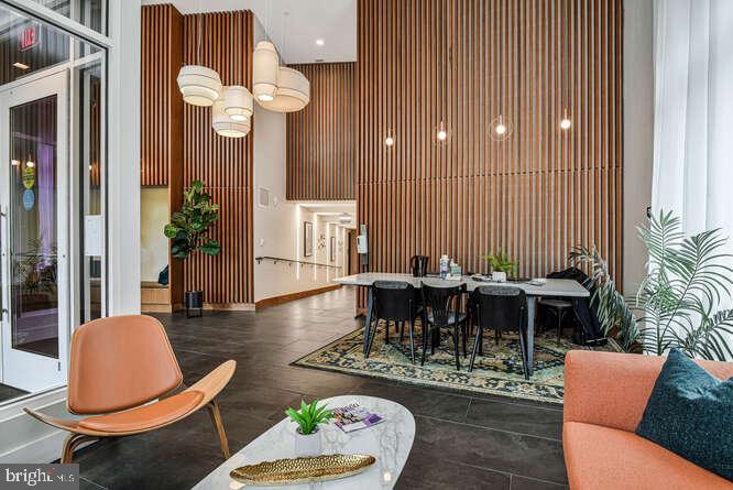 6803 Cameron Drive Northwest, Unit 314 Washington, DC 20012 - Photo 12 of 25 a dining room with furniture a rug and a chandelier