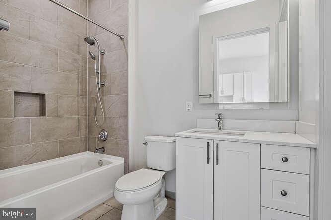 6803 Cameron Drive Northwest, Unit 314 Washington, DC 20012 - Photo 2 of 25 a bathroom with a sink a toilet and shower