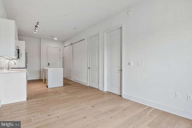 6803 Cameron Drive Northwest, Unit 314 Washington, DC 20012 - Photo 23 of 25 a view of a kitchen with white cabinets