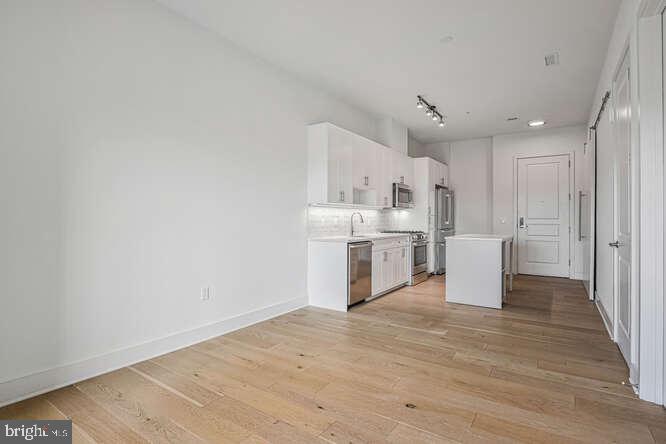 6803 Cameron Drive Northwest, Unit 314 Washington, DC 20012 - Photo 24 of 25 a view of a kitchen with wooden floor
