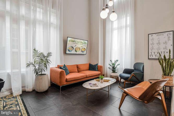 6803 Cameron Drive Northwest, Unit 314 Washington, DC 20012 - Photo 25 of 25 a living room with furniture and a large window