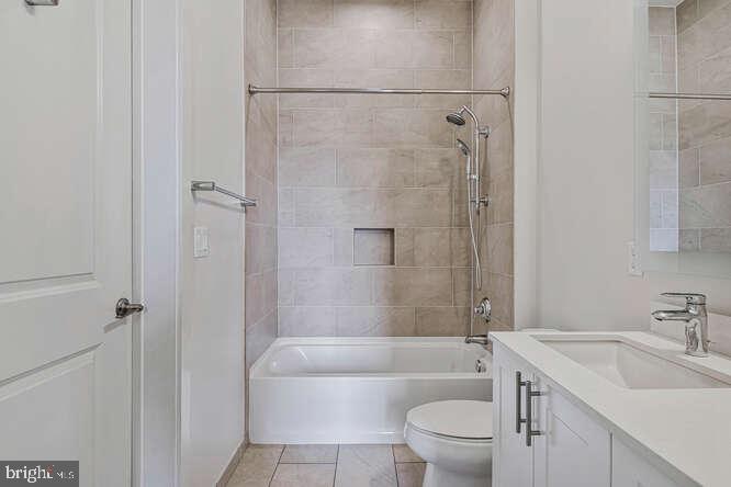 6803 Cameron Drive Northwest, Unit 314 Washington, DC 20012 - Photo 3 of 25 a bathroom with a sink a toilet and shower