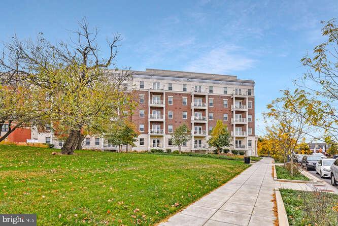 6803 Cameron Drive Northwest, Unit 314 Washington, DC 20012 - Photo 9 of 25 a view of a building with a yard