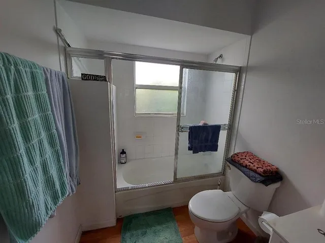 a bathroom with a toilet and a shower