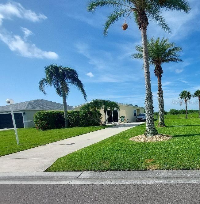 1000 Southwest 44th Boulevard Okeechobee, FL 34974 - Photo 5 of 11 a front view of a house with a yard and palm trees