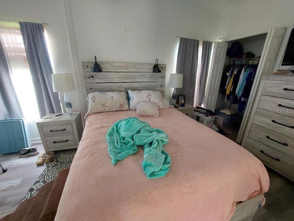 1000 Southwest 44th Boulevard Okeechobee, FL 34974 - Photo 10 of 11 a bedroom with a bed window and mirror