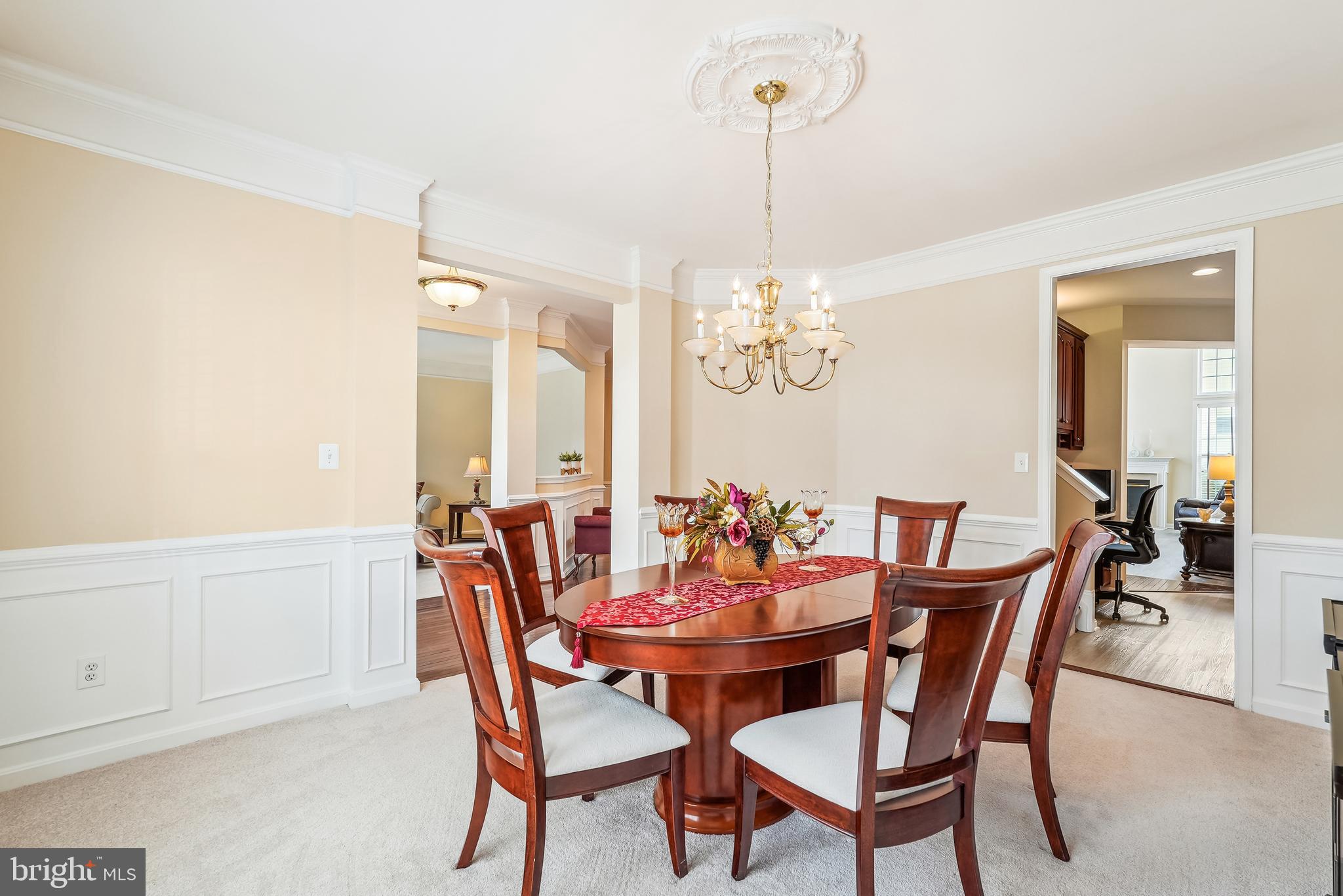 42801 Ridgeway Drive Broadlands, VA 20148 - Photo 16 of 40 a view of a dining room with furniture a chandelier and wooden floor