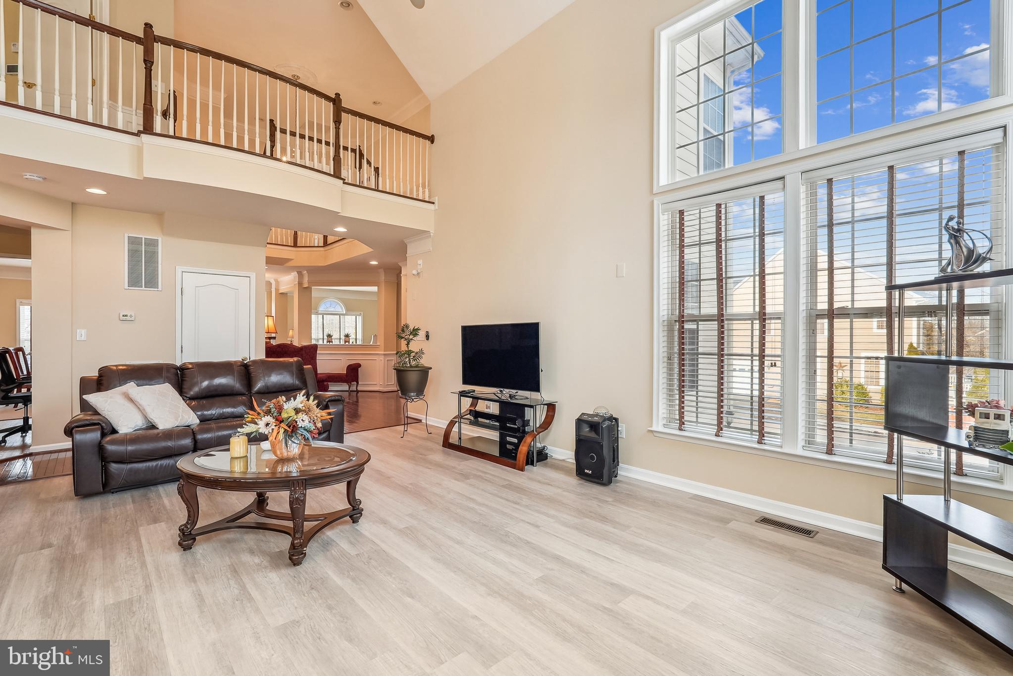 42801 Ridgeway Drive Broadlands, VA 20148 - Photo 18 of 40 a living room with furniture a flat screen tv and a floor to ceiling window