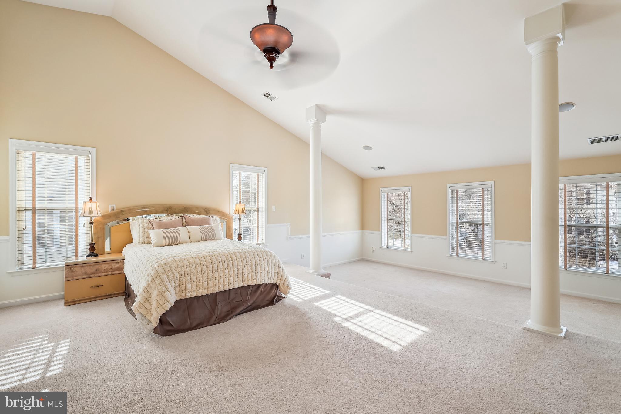 42801 Ridgeway Drive Broadlands, VA 20148 - Photo 26 of 40 a spacious bedroom with a large bed and a chandelier