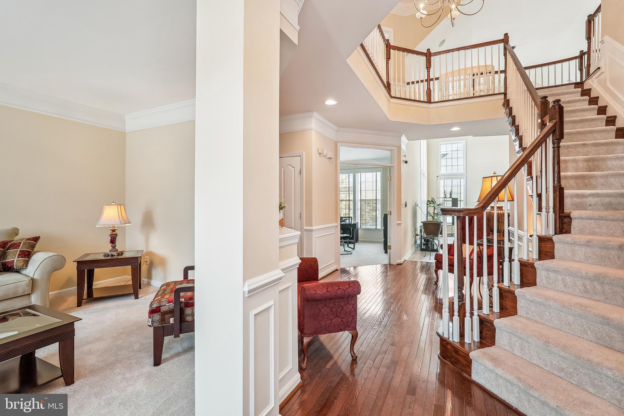 42801 Ridgeway Drive Broadlands, VA 20148 - Photo 5 of 40 a view of a livingroom with furniture stairs wooden floor and a chandelier