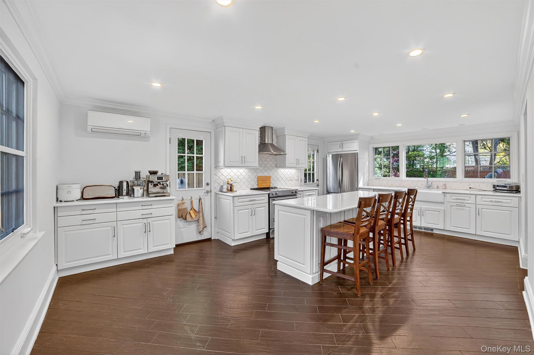 20 Whistler Road Scarsdale, NY 10583 - Photo 11 of 47 a kitchen with white cabinets and wooden floor