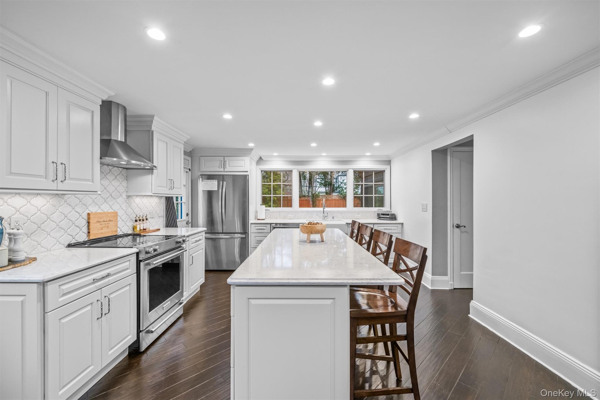 20 Whistler Road Scarsdale, NY 10583 - Photo 13 of 47 a kitchen with kitchen island a stove a sink a refrigerator and cabinets