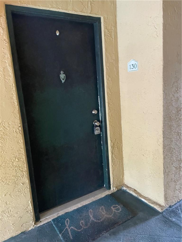 5686 Rock Island Road, Unit 130 Tamarac, FL 33319 - Photo 8 of 23 an empty room with wooden floor
