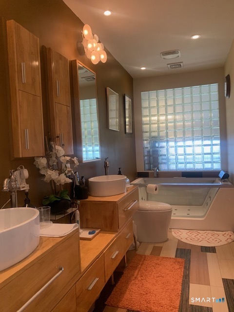 200 Brittany Farms Road, Unit D New Britain, CT 06053 - Photo 23 of 36 a room with furniture a large window and furniture