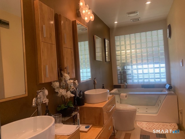 200 Brittany Farms Road, Unit D New Britain, CT 06053 - Photo 24 of 36 a bathroom with a tub sink and mirror