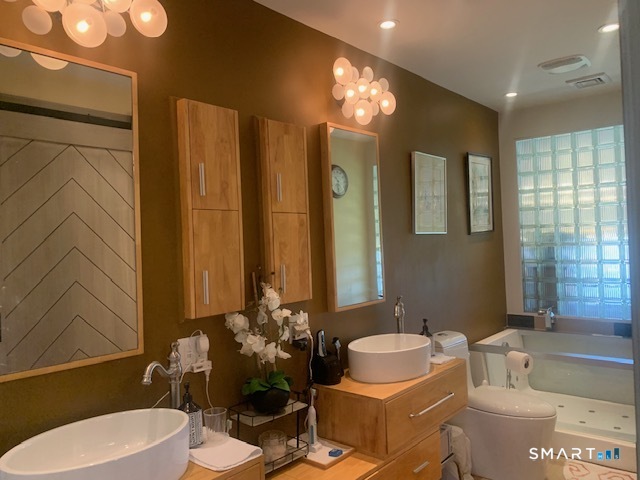 200 Brittany Farms Road, Unit D New Britain, CT 06053 - Photo 25 of 36 a bathroom with a sink and mirror with toilet