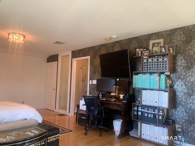 200 Brittany Farms Road, Unit D New Britain, CT 06053 - Photo 26 of 36 a room with furniture and a flat screen tv