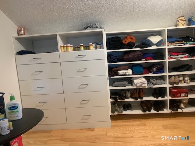 200 Brittany Farms Road, Unit D New Britain, CT 06053 - Photo 27 of 36 a view of walk in closet with clothes and shoes