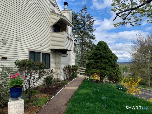 200 Brittany Farms Road, Unit D New Britain, CT 06053 - Photo 33 of 36 a front view of a house with a yard and potted plants