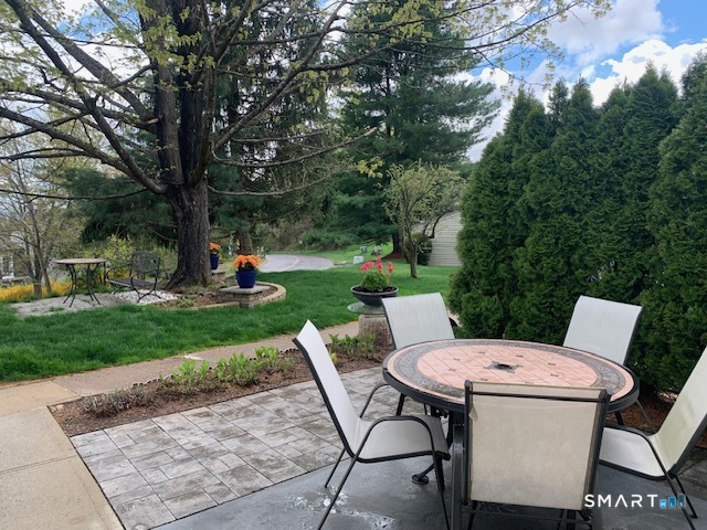 200 Brittany Farms Road, Unit D New Britain, CT 06053 - Photo 36 of 36 a view of a patio with table and chairs and a large tree