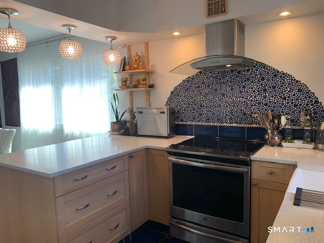 200 Brittany Farms Road, Unit D New Britain, CT 06053 - Photo 6 of 36 a kitchen with kitchen island a sink stainless steel appliances and cabinets