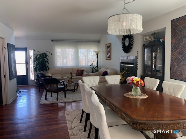200 Brittany Farms Road, Unit D New Britain, CT 06053 - Photo 7 of 36 a dining room with furniture a chandelier and wooden floor