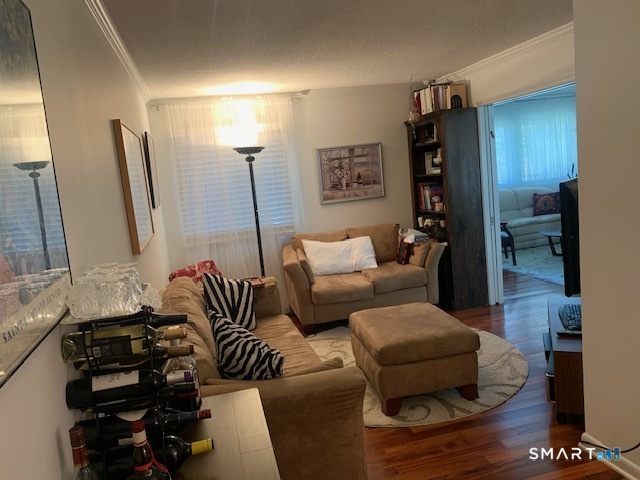 200 Brittany Farms Road, Unit D New Britain, CT 06053 - Photo 8 of 36 a living room with furniture and a wooden floor