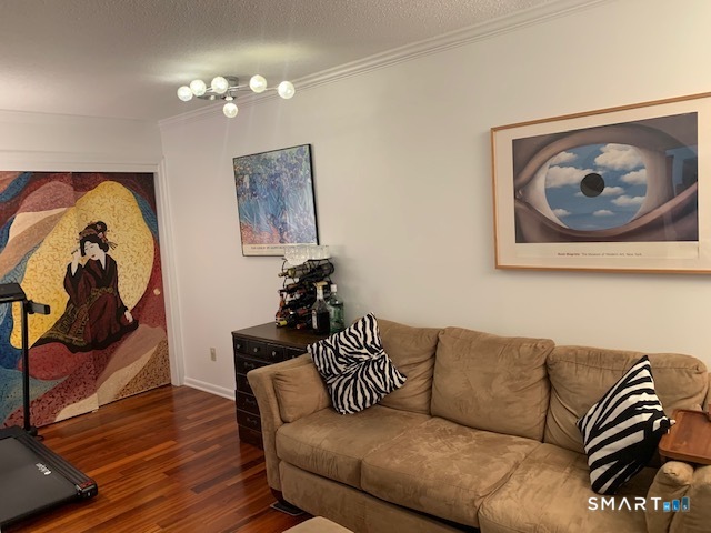 200 Brittany Farms Road, Unit D New Britain, CT 06053 - Photo 9 of 36 a living room with furniture and a painting on the wall