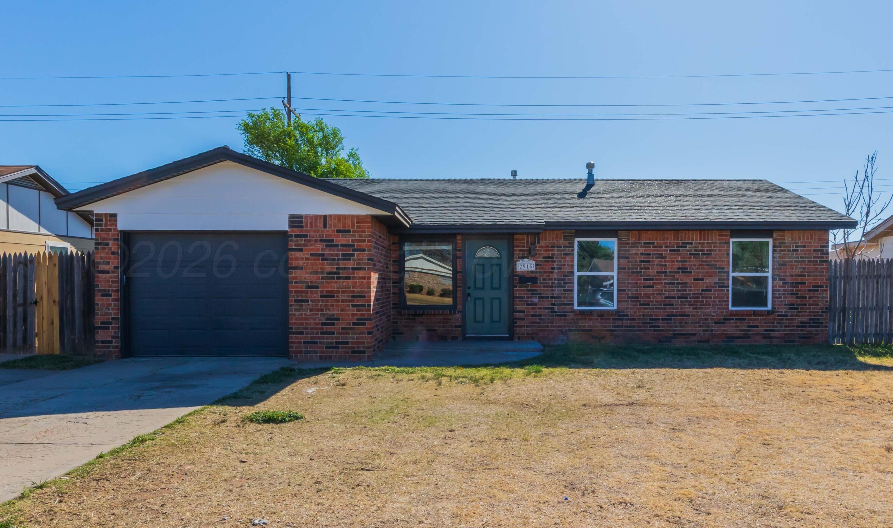 2915 Hodges Street Amarillo, TX 79103 - Photo 1 of 34 a front view of a house with a yard and garage