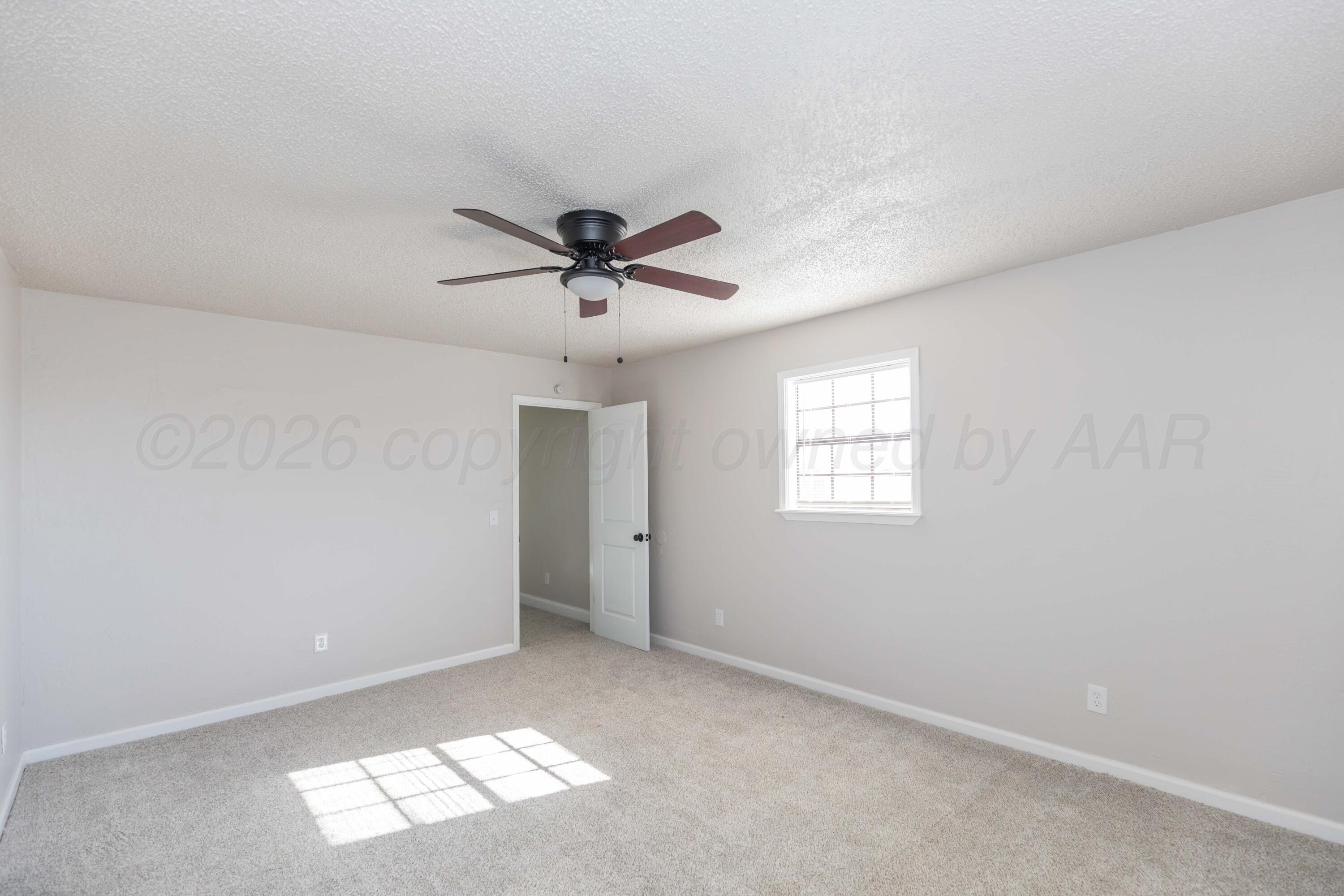 2915 Hodges Street Amarillo, TX 79103 - Photo 16 of 34 a view of a big room with carpet and windows