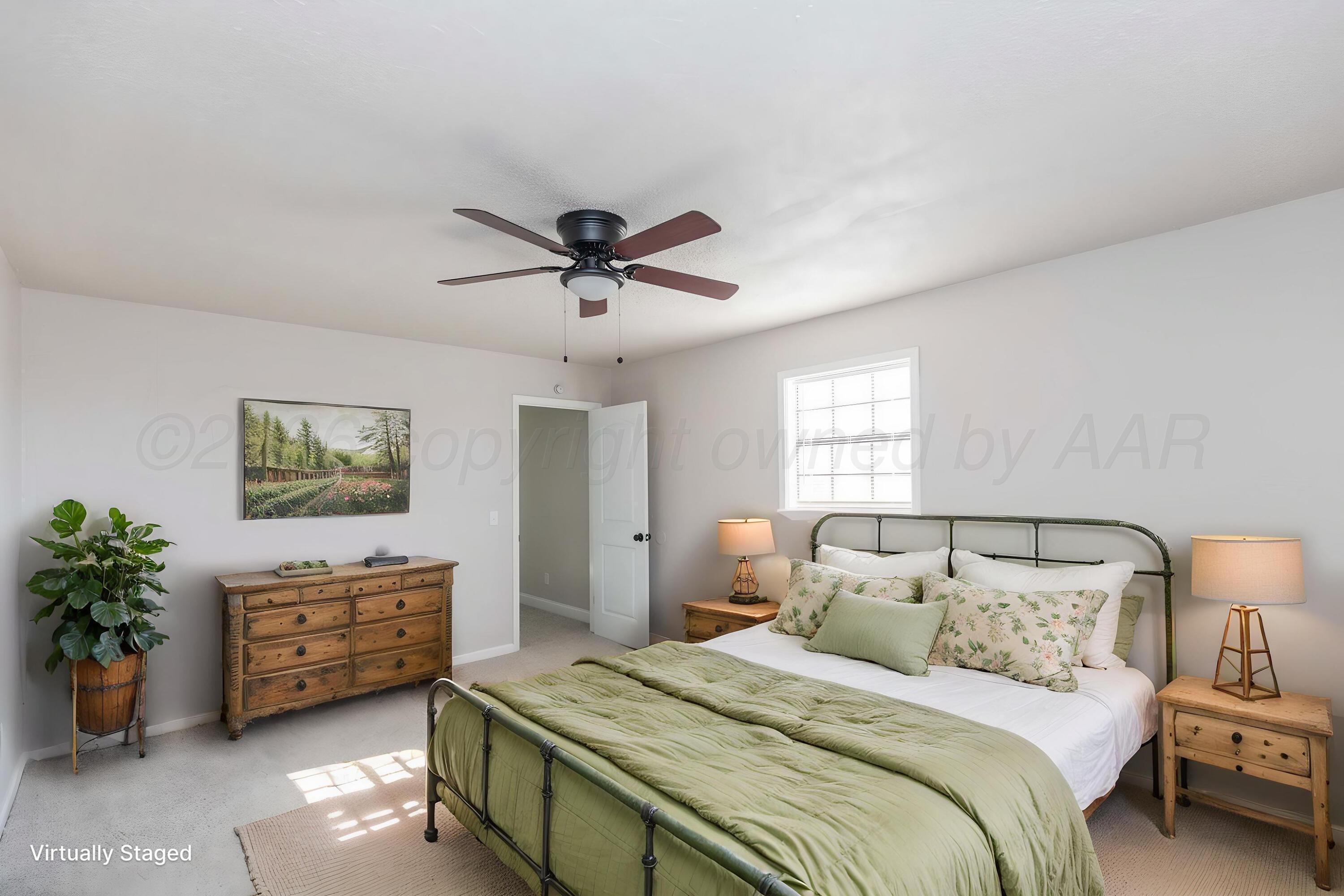 2915 Hodges Street Amarillo, TX 79103 - Photo 17 of 34 a bedroom with a bed a couch and potted plant