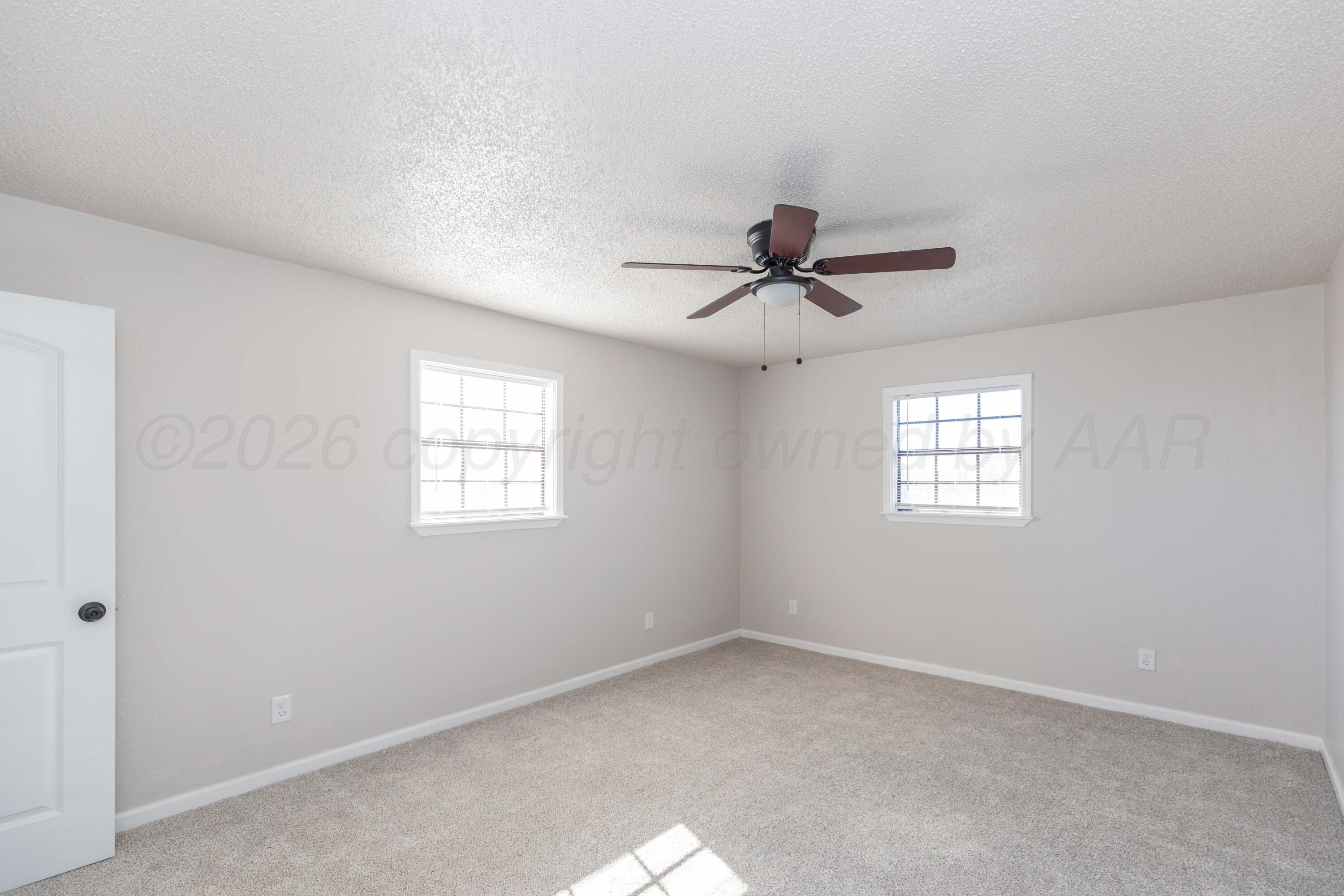 2915 Hodges Street Amarillo, TX 79103 - Photo 19 of 34 a view of a room with a ceiling fan and window