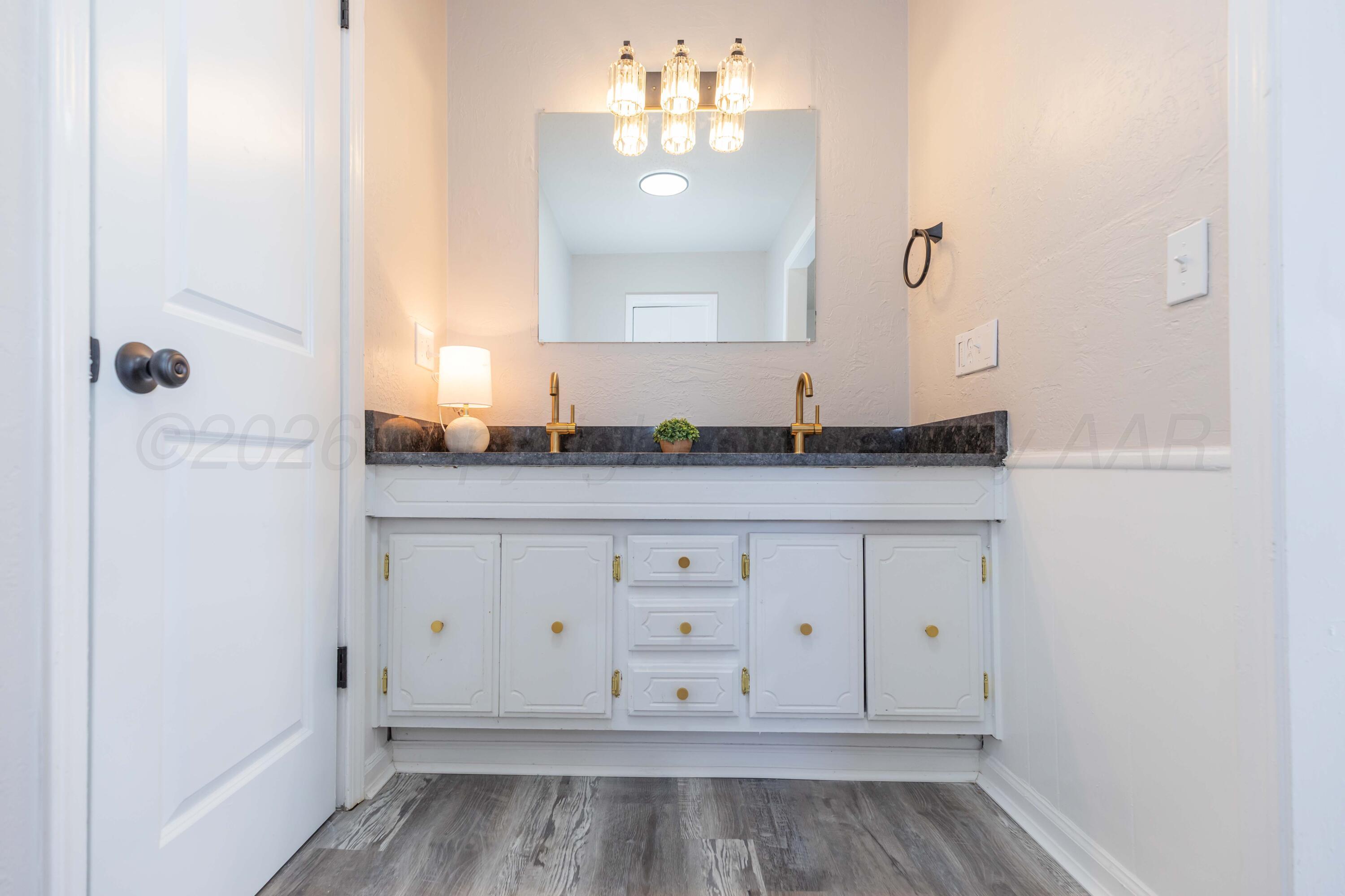 2915 Hodges Street Amarillo, TX 79103 - Photo 21 of 34 a bathroom with a sink and a mirror
