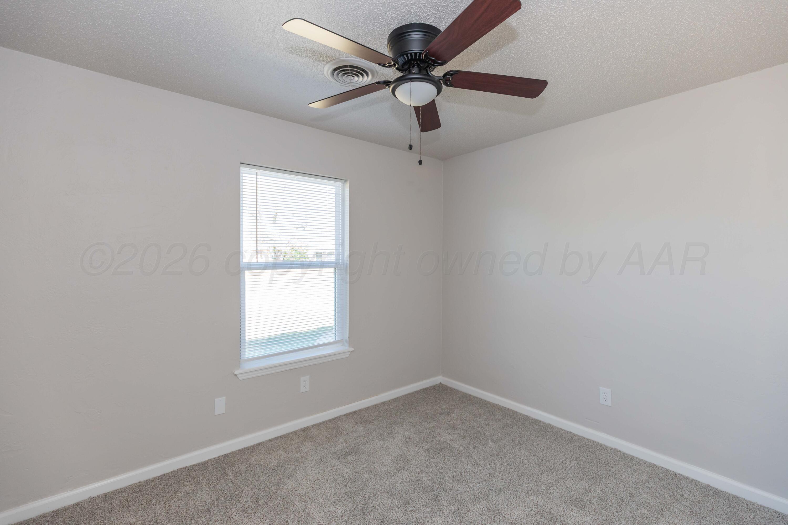 2915 Hodges Street Amarillo, TX 79103 - Photo 26 of 34 an empty room with a window and a fan