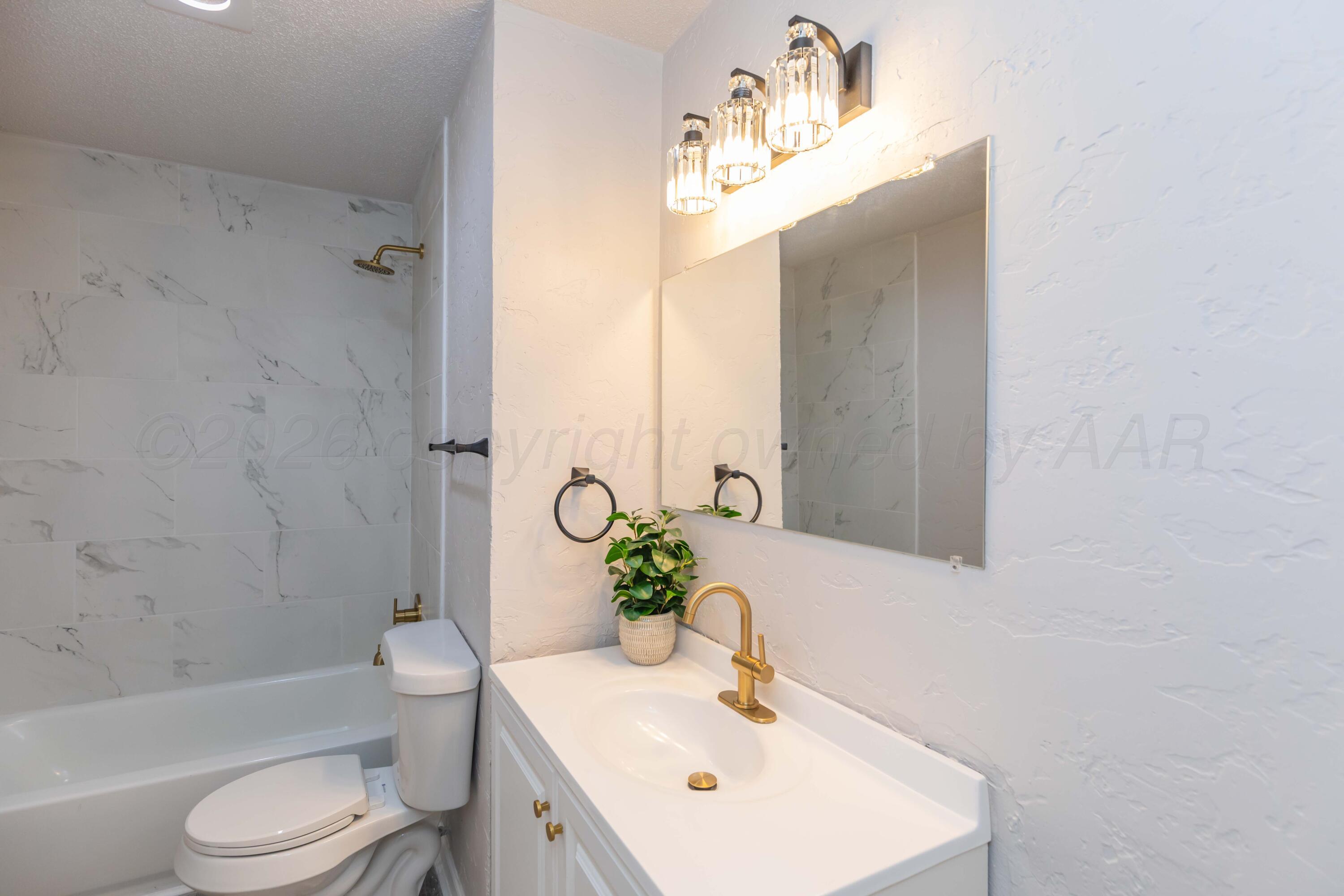 2915 Hodges Street Amarillo, TX 79103 - Photo 27 of 34 a bathroom with a sink toilet and shower