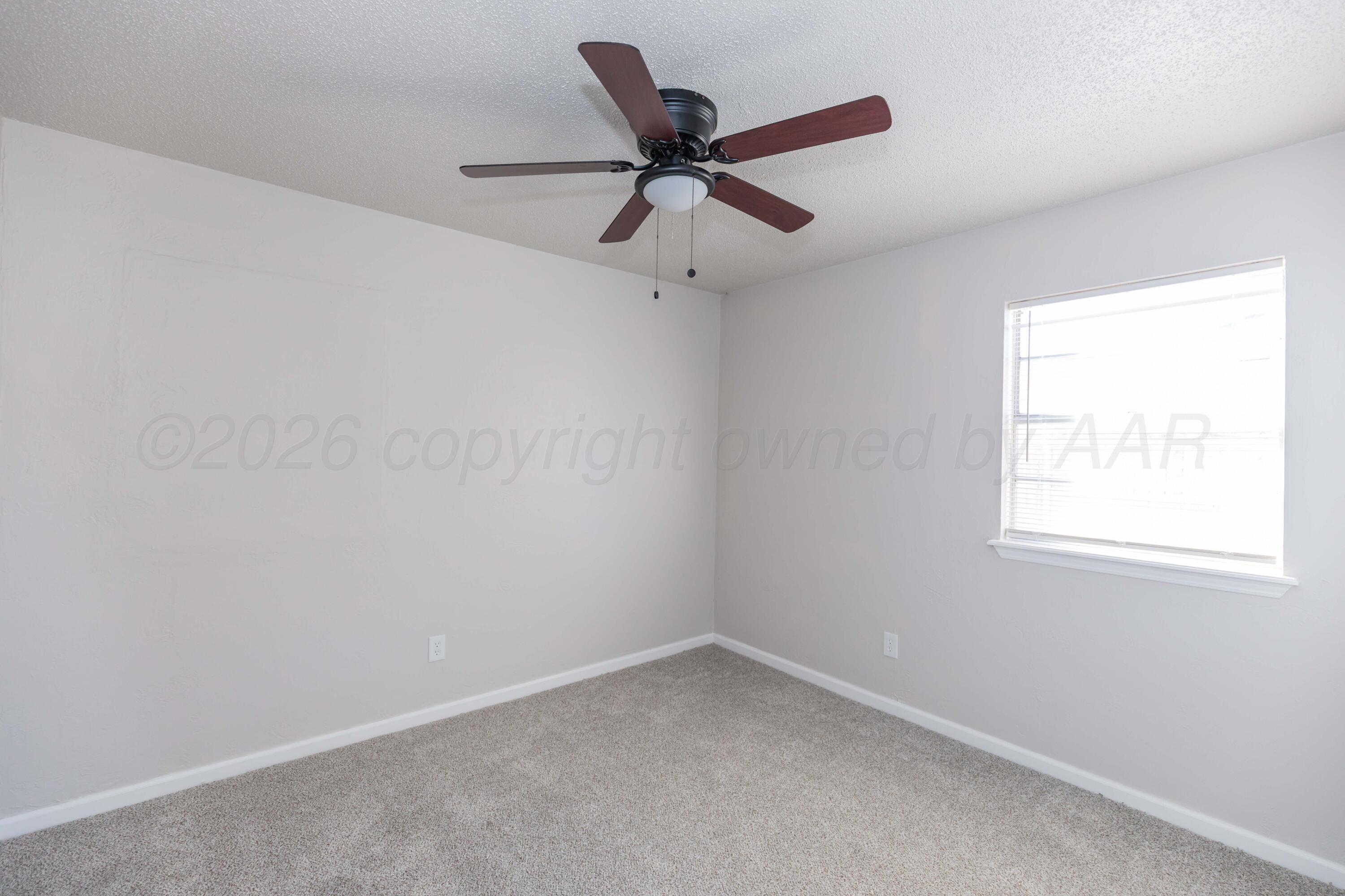 2915 Hodges Street Amarillo, TX 79103 - Photo 32 of 34 an empty room with a window and a fan