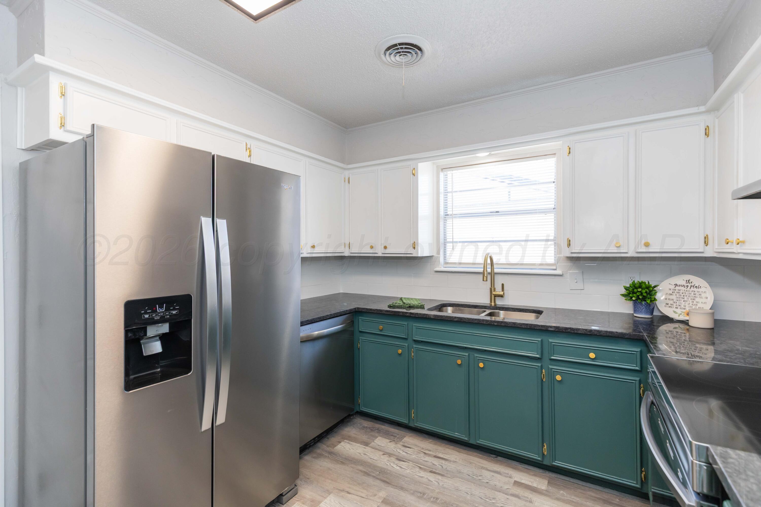 2915 Hodges Street Amarillo, TX 79103 - Photo 6 of 34 a kitchen with a refrigerator sink and microwave