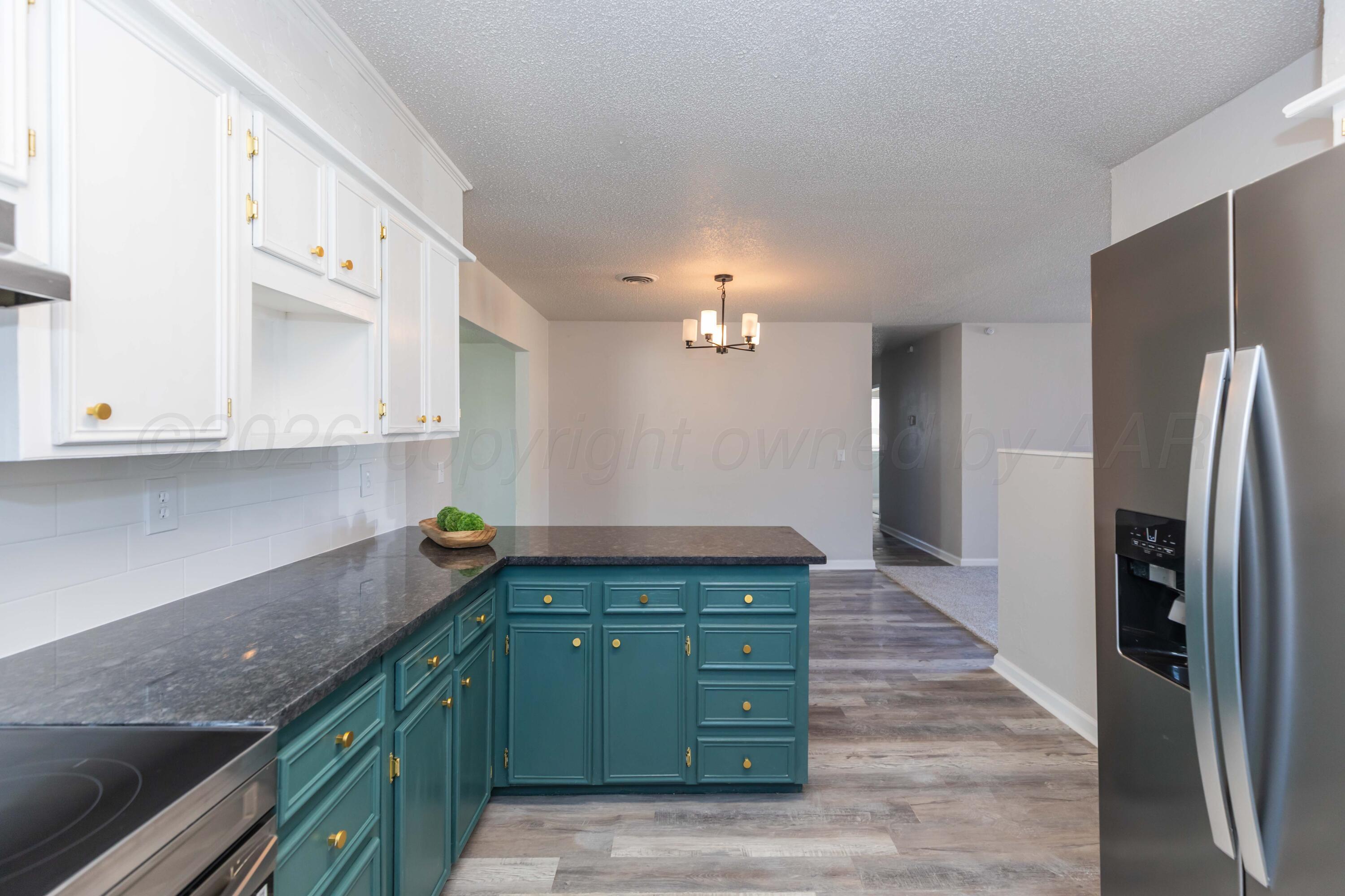 2915 Hodges Street Amarillo, TX 79103 - Photo 7 of 34 a kitchen with a refrigerator and a sink