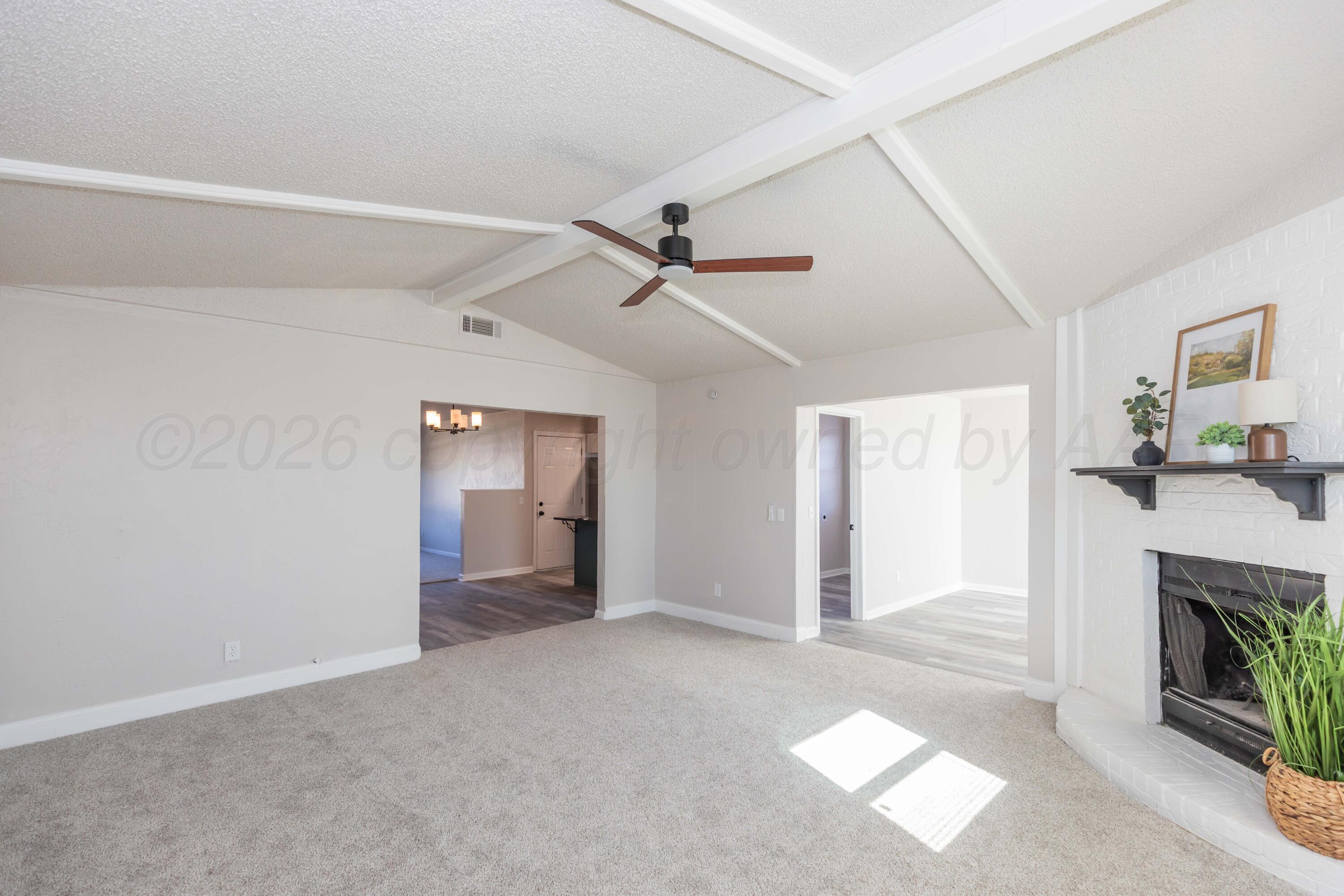 2915 Hodges Street Amarillo, TX 79103 - Photo 10 of 34 a view of a livingroom with a fireplace and a ceiling fan