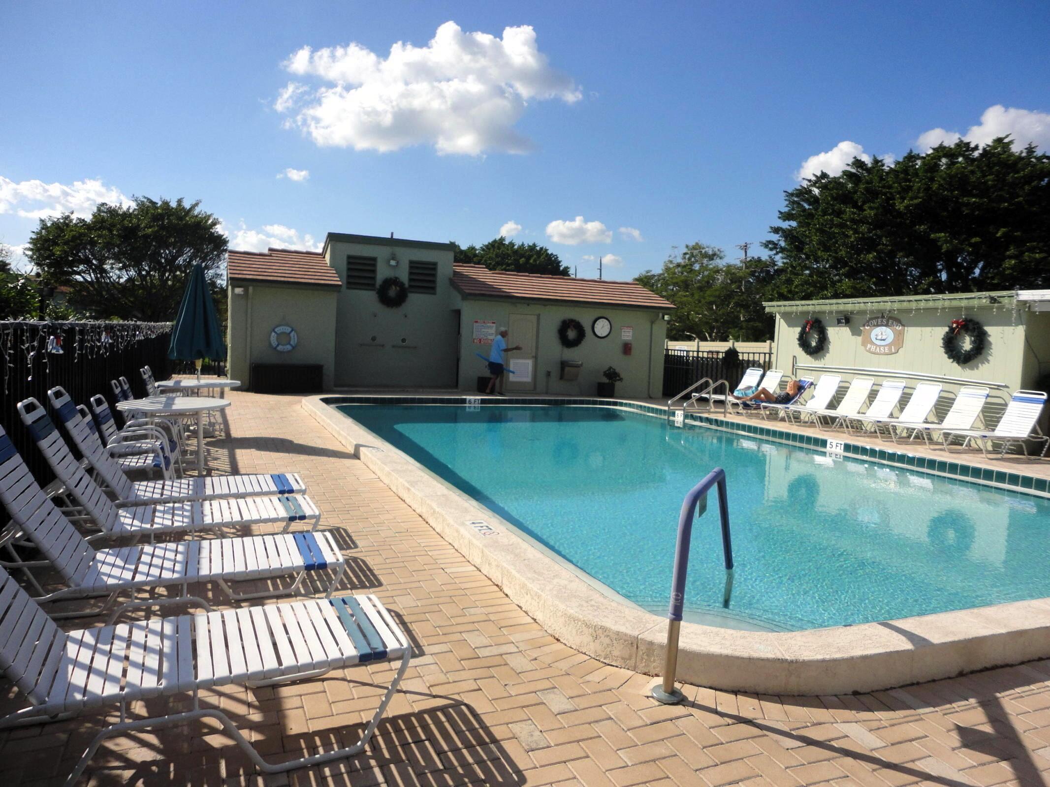 5433 Southeast Miles Grant Road, Unit E104 Stuart, FL 34997 - Photo 16 of 16 a outdoor view with a sitting space