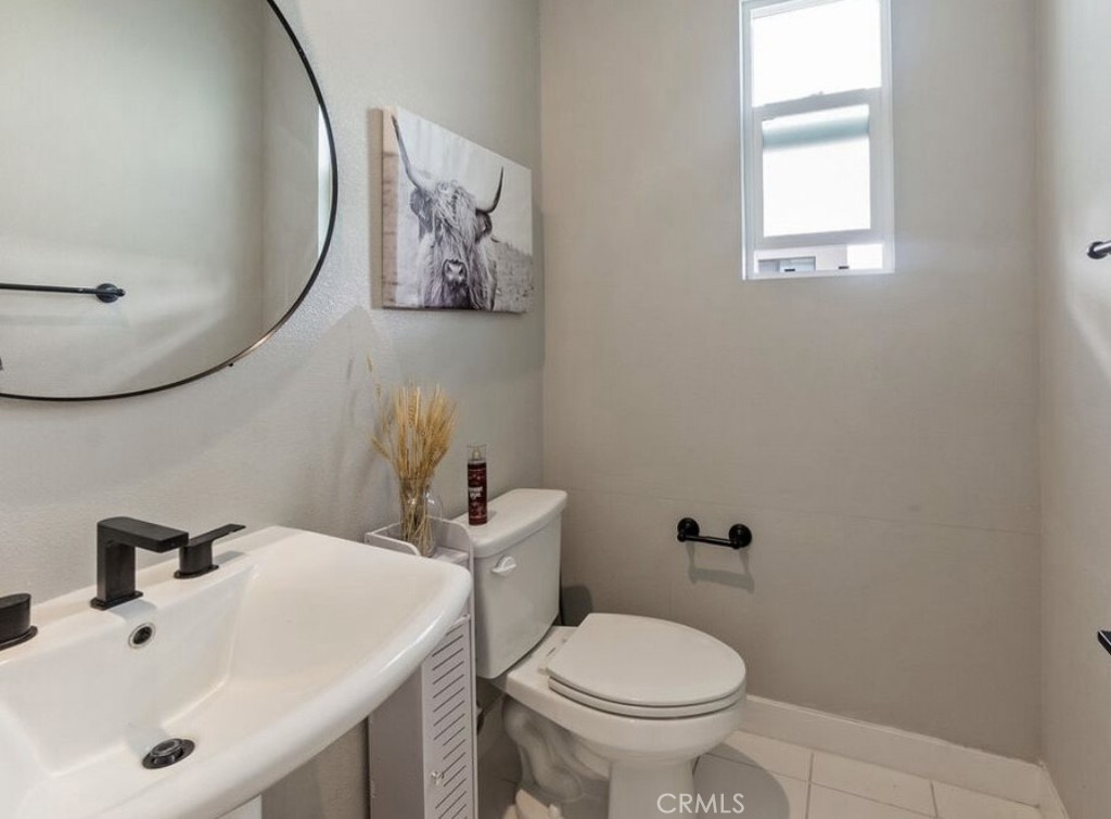 2111 Copper Walk Gardena, CA 90249 - Photo 18 of 33 a bathroom with a toilet sink and mirror